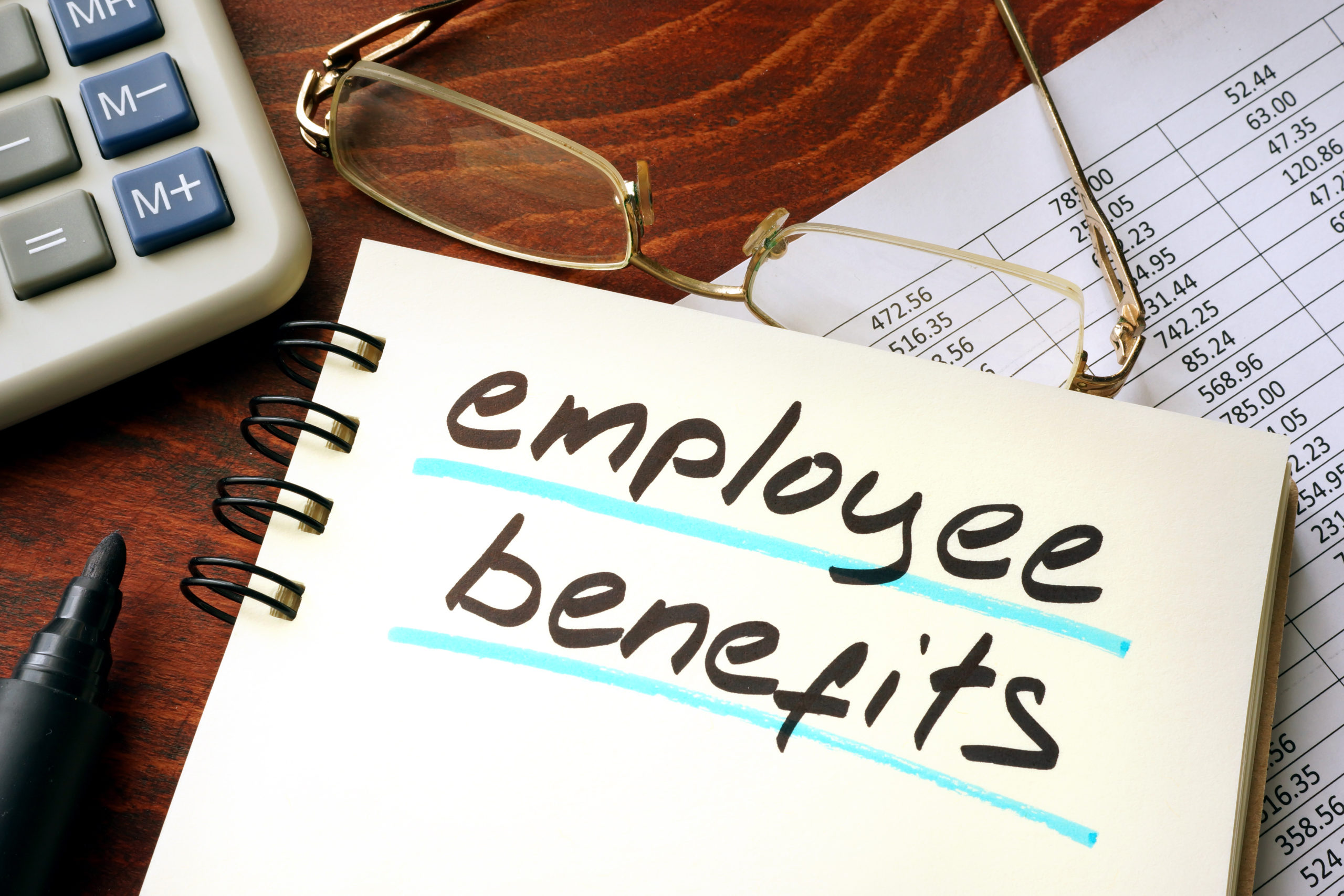Employee benefits written on a notepad. Business concept.