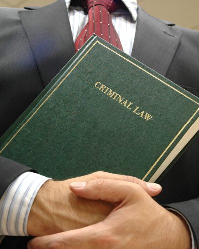 lawyer holding criminal law book