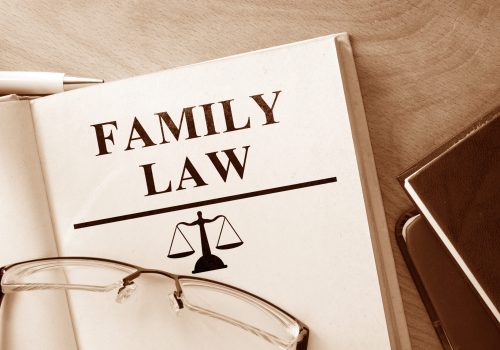 Book with words family law and glasses.